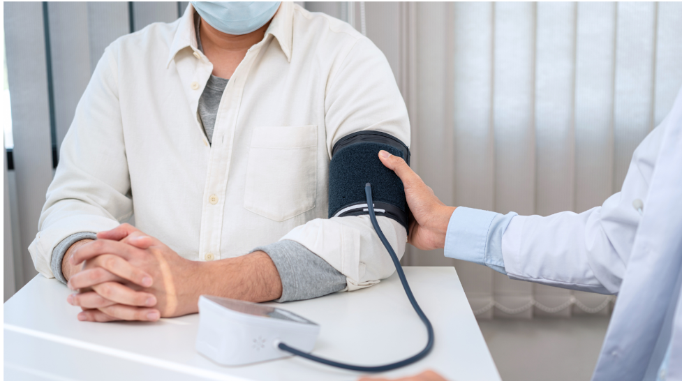 Worker getting checked for his blood pressure